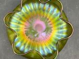 a green plate with a colorful flower design on it