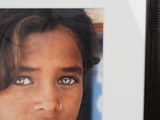 a picture of a young girl with blue eyes in a picture frame