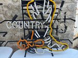 a neon sign that says country music on a table