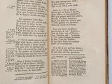 an open book with a page in it on a table