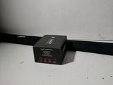 a black box sitting on the floor next to a white wall