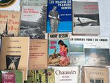 many books on a table with a white table cloth