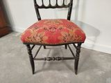a chair with a red and gold upholstered seat