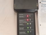a black electronic device sitting on a table next to a box