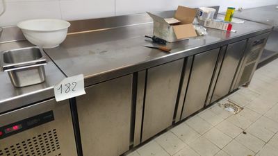 a large stainless steel counter with a bowl on top of it