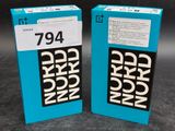 two blue boxes with black and white words on them sitting on a table