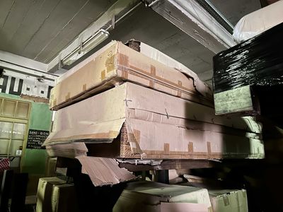 many boxes stacked on top of each other in a room