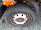 a flat tire on the flatbed of a truck