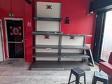 a room with a red couch and a black chair