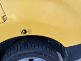 a close up of a yellow truck tire with a sticker on it