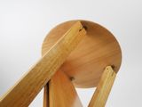 a wooden chair that has a wooden seat on it