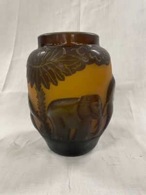 un vase marron orné d'un éléphant sur fond blanc