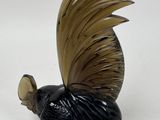 a figurine of a bird with a long tail