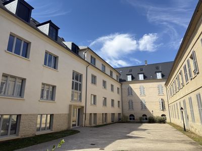 a courtyard in the middle of a building with several windows