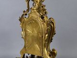 an image of a gold clock with a bird on top of it
