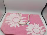 a pink bag with a rope on it sitting on a table