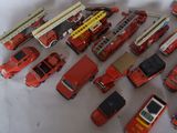 a lot of toy fire trucks that are on the table