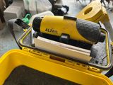 a yellow box with a tool on top of it