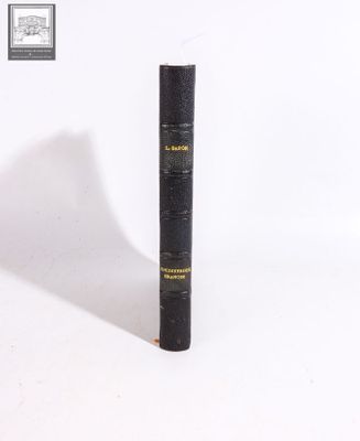 a black book that is sitting on a white surface