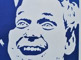 a blue and white poster with a picture of a man laughing