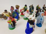 many figurines of people that are sitting on a table