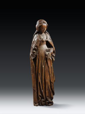 a wooden statue of a woman holding a child