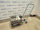 a machine that is sitting on the floor in front of a wall