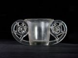 a glass cup that is sitting on a table