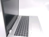 a silver laptop with a black keyboard on a white surface