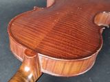 a close up of a violin on a black surface
