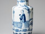 a blue and white vase with a picture of a man on it