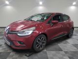 a red car is parked on a checkered floor in a garage