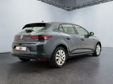 the rear view of a grey car in a showroom