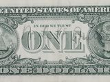 the front of a one dollar bill with a picture of an eagle on it