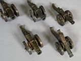 six antique cast iron pipe valves on a white surface