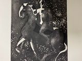 a black and white photo of a woman riding a horse