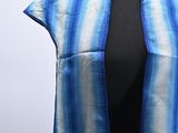 an image of a blue and white striped scarf on a mannequin