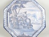 a blue and white plate with a picture of a man on a horse