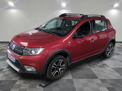 the red dacia is parked in a room with a checkered floor