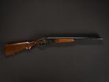 a rifle with a wooden barrel on a black background