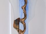 a blue vase with a snake on it on a table