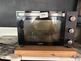 a toaster oven sitting on a counter with a price tag on it