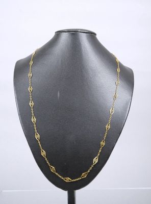 a black mannequin with a gold chain on it