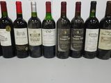 several bottles of wine are lined up on a table