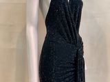 a mannequin wearing a black dress with a tie around the waist