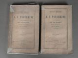 two old books sitting on top of a table next to each other