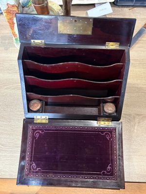 a wooden box that has a bunch of items inside of it