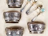 five silver spoons and two silver bowls in a box