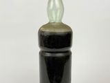 black and green glass bottle with a wooden lid