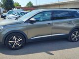 the grey car is parked in the parking lot near other cars